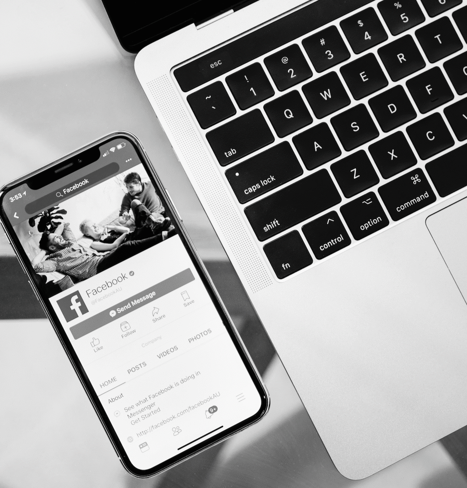 laptop and phone showing a Facebook page